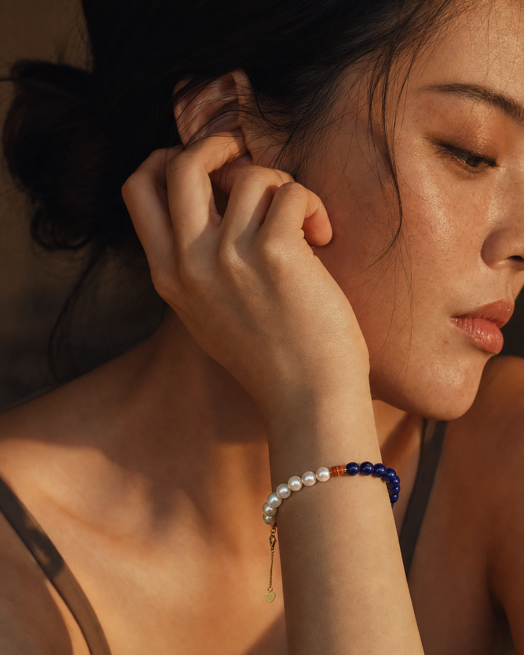 Model wearing an Akoya pearl and gemstone bracelet