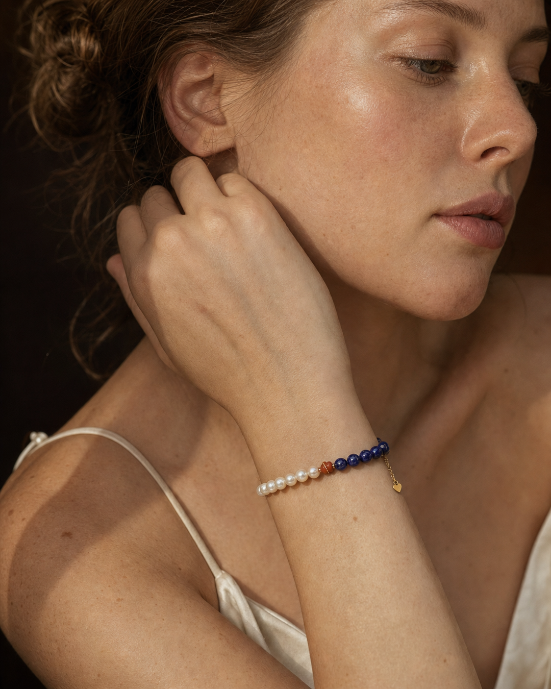 Model wearing an Akoya pearl and blue crystal bracelet