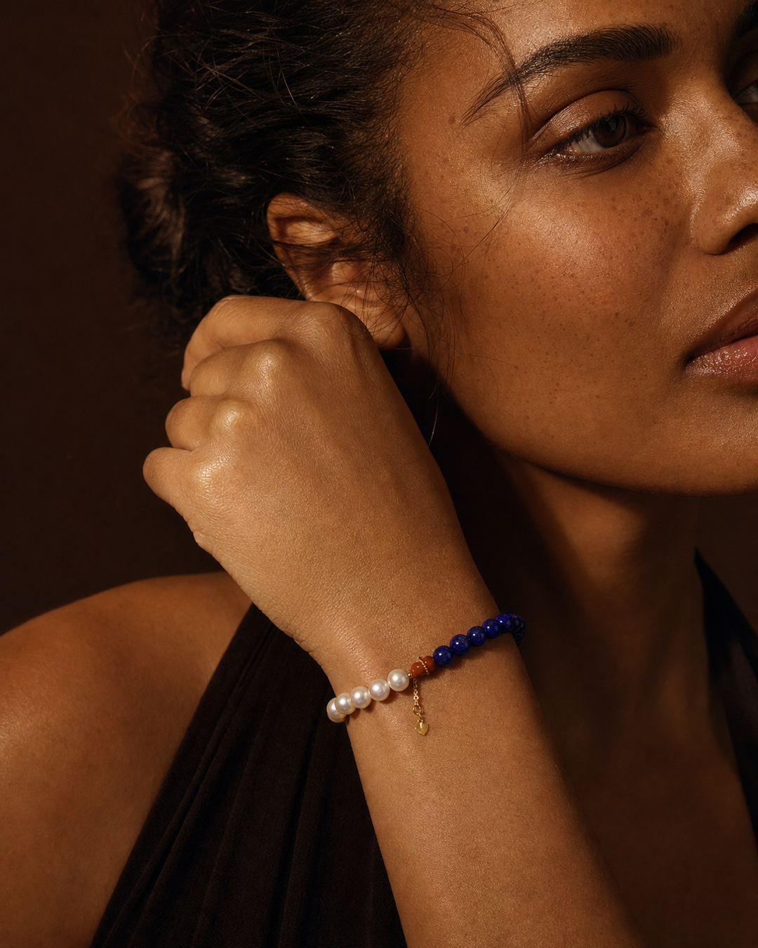 Model wearing an Akoya pearl and blue crystal bracelet